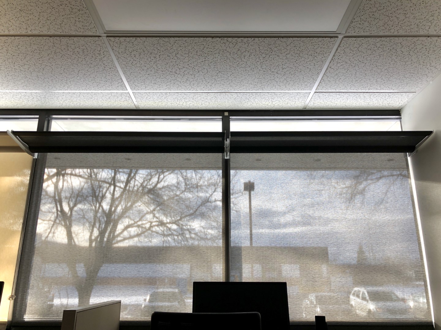 Office with translucent shades. Daylight is significantly reduced, but light shelves still reflect daylight across the ceiling.